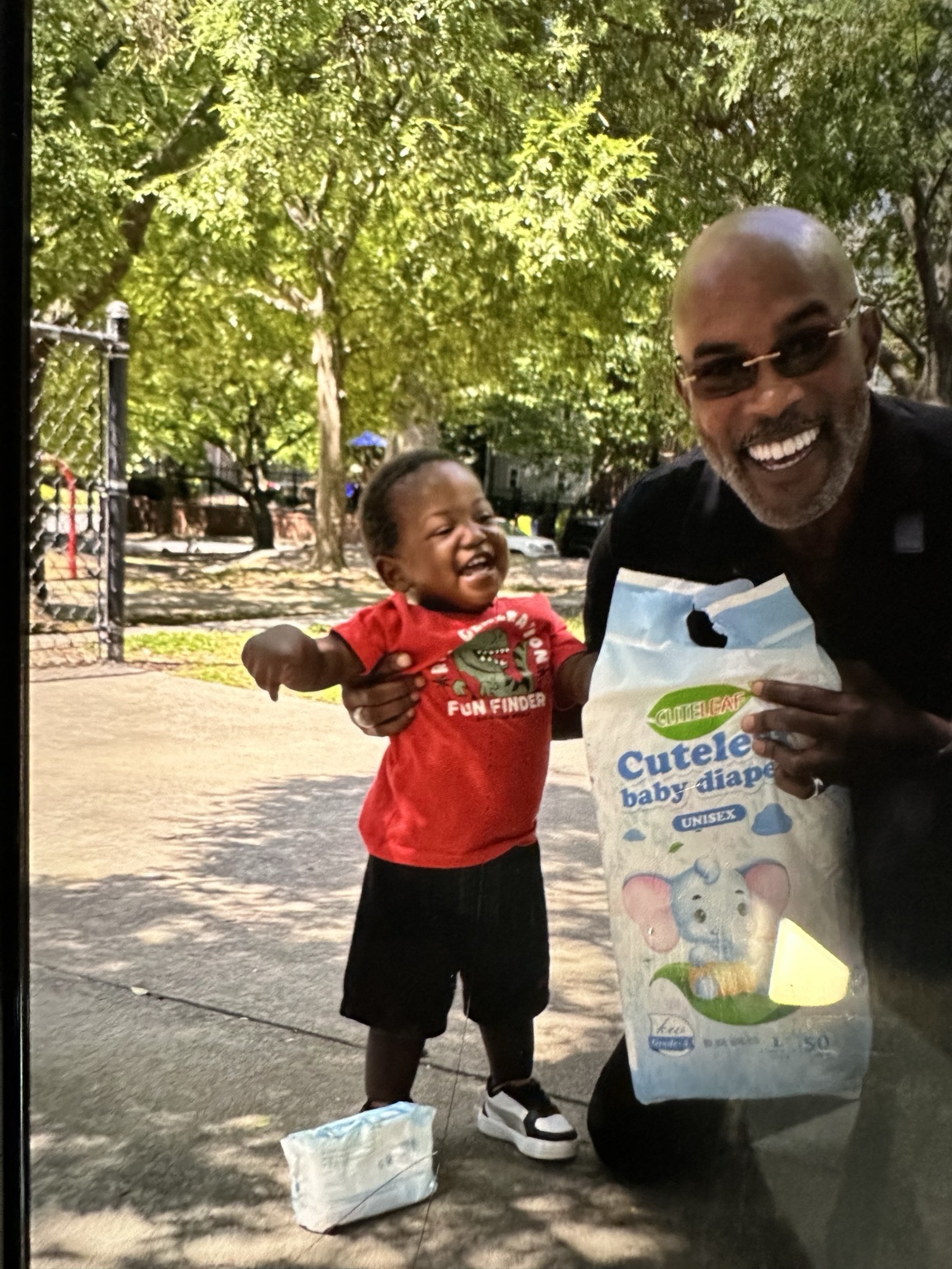 Dr. Grant sharing a joyful moment with a young child at a community distribution